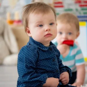Two toddlers playing in colorful playroom